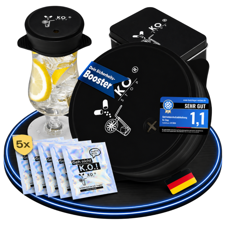 Schwarze KO STOP Silikondeckel mit Logo auf einem Glas und neben einer Metallbox.